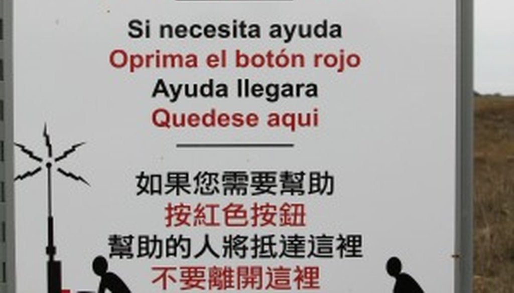 Rescue beacon signs arrayed in the brush country near the Texas-Mexico border are in English, Spanish and Chinese. (Source: Rio Grande Valley Sector Border Patrol).