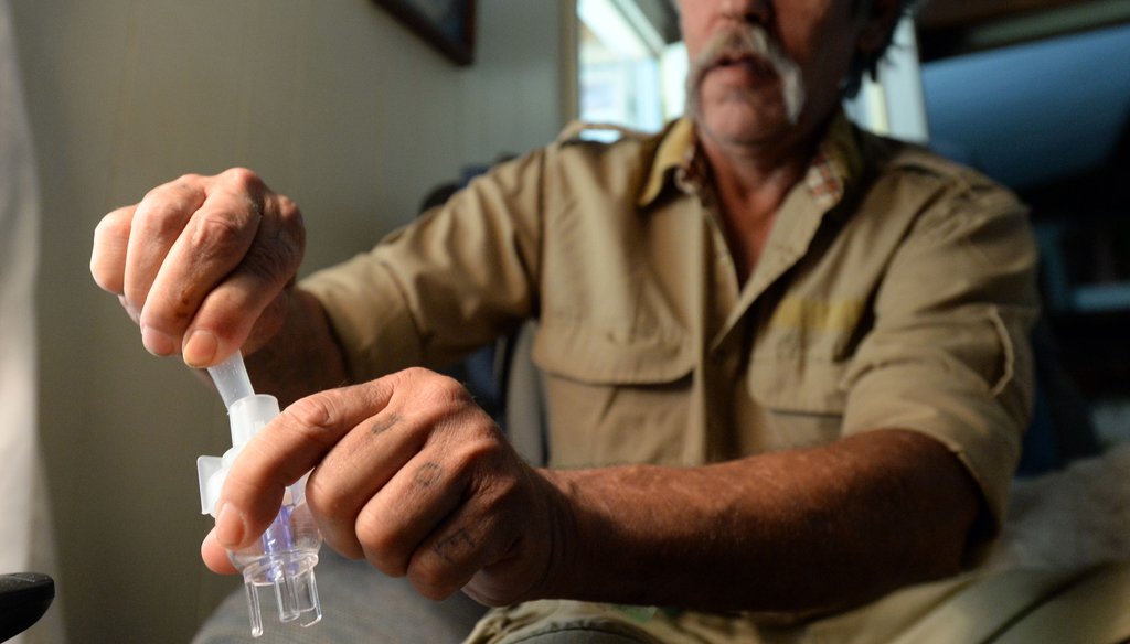 Dale Zipperer is a military veteran without insurance who suffers from chronic bronchitis and emphysema. He prepares to take albuterol sulfate inhalation solution using a Misty-Neb nebulizer for his medical care. Photo credit: Hyosub Shin/AJC.