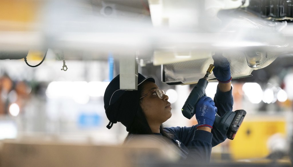 An employee works on a car on the assembly line at the BMW Spartanburg plant in Greer, S.C., in 2022. (AP)