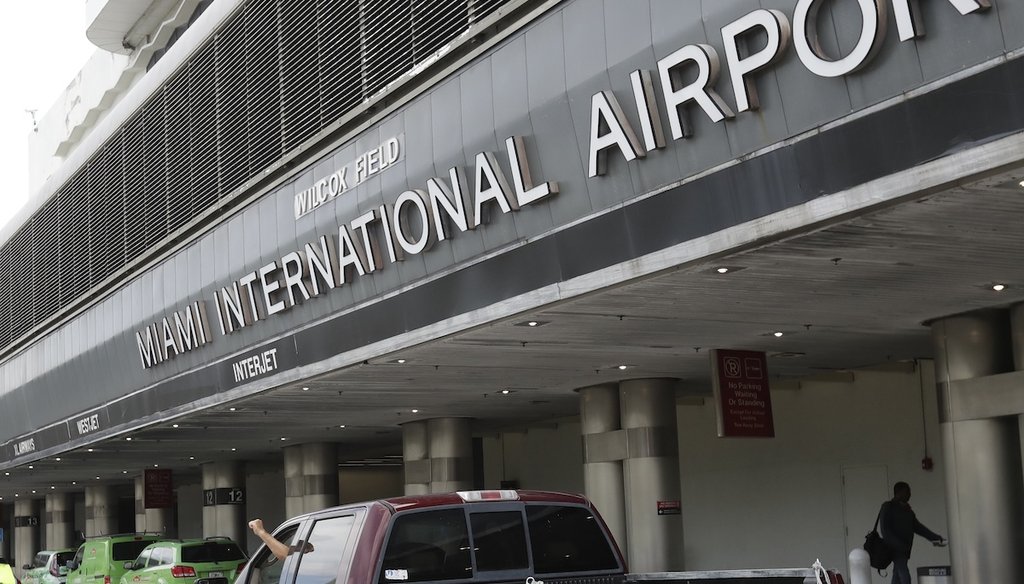 Vehicles pass the entrance to Miami International Airport in Miami Tuesday, May 12, 2020. (AP)