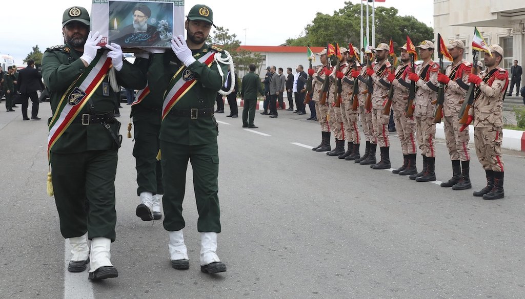 In this photo released by the Iranian Presidency Office, Revolutionary Guard members carry the flag-draped coffin of President Ebrahim Raisi during a funeral ceremony for him and his companions who were killed in a helicopter crash. (AP)