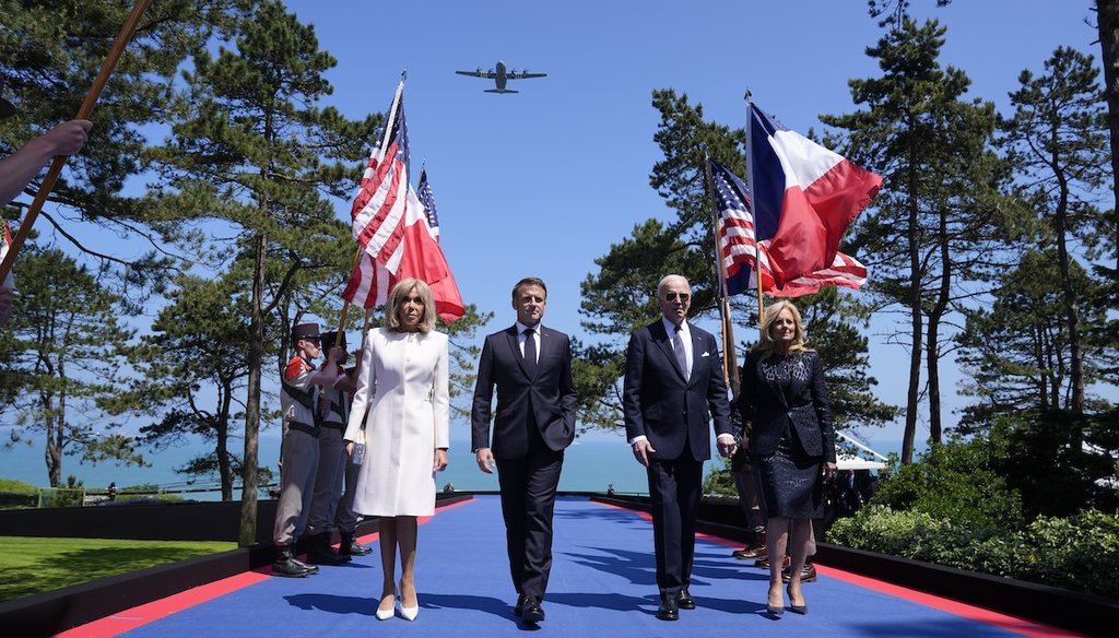 U.S. President Joe Biden, first lady Jill Biden, French President Emmanuel Macron, his wife Brigitte Macron, walk onstage June 6, 2024, during ceremonies to mark the 80th anniversary of D-Day in Normandy, France. (AP)