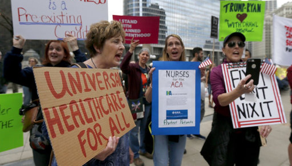 Protesters gather across the Chicago River from Trump Tower to rally against the repeal of the Affordable Care Act on March 24, 2017. (AP)