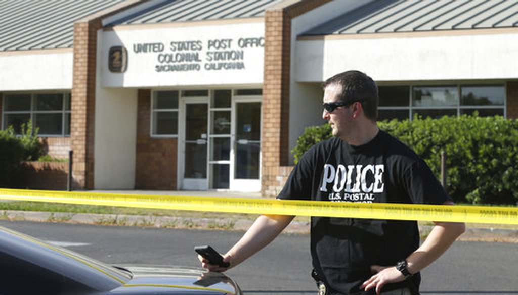 A U.S. Postal inspector stands behind yellow police tape outside the Colonial Station post office where a suspicious package addressed to U.S. Sen. Kamala Harris, (D-Cali), was found Oct. 26, 2018, in Sacramento, Calif. (AP Photo/Rich Pedroncelli)