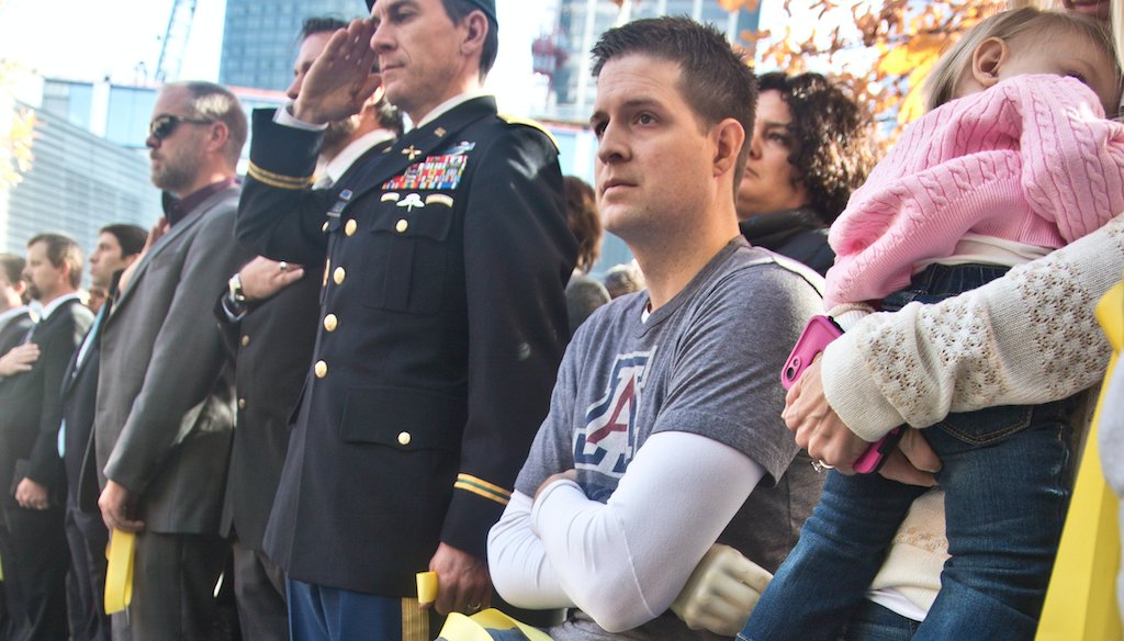 Brian Kolfage, center, sits in a wheelchair during the National September 11 Memorial and Museum's "Salute to Service" tribute honoring U.S. veterans in New York. (AP)