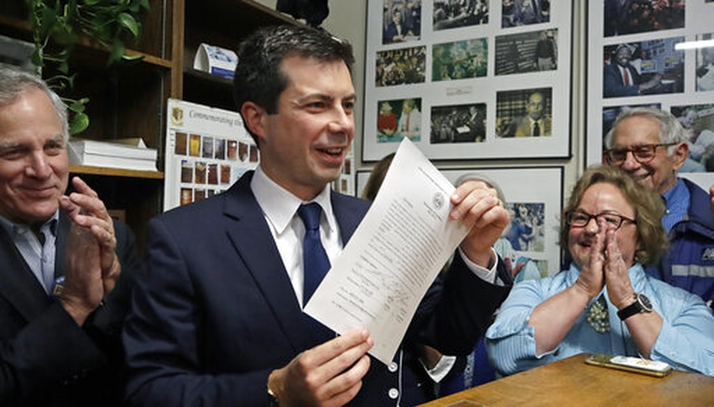 Democratic presidential candidate South Bend, Ind., Mayor Pete Buttigieg holds up the paper he signed to be placed on the New Hampshire primary ballot, at the Statehouse, Oct. 30, 2019, in Concord, N.H. (AP/Elise Amendola)