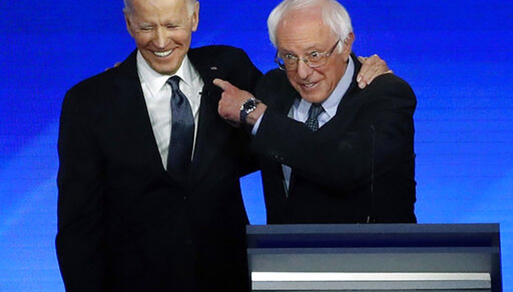 Former Vice President Joe Biden embraces Sen. Bernie Sanders, I-Vt., during a Democratic presidential primary debate, Feb. 7, 2020 at Saint Anselm College in Manchester, N.H. (AP/Elise Amendola)