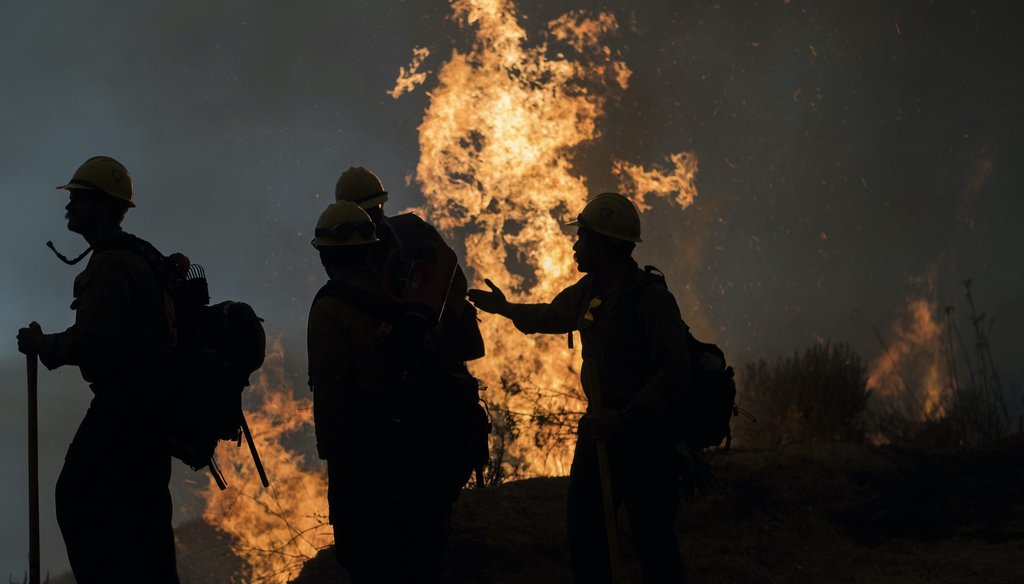 Firefighters monitor a controlled burn along Nacimiento-Fergusson Road to help contain the Dolan Fire near Big Sur, Calif., on Sept. 11, 2020. (AP)