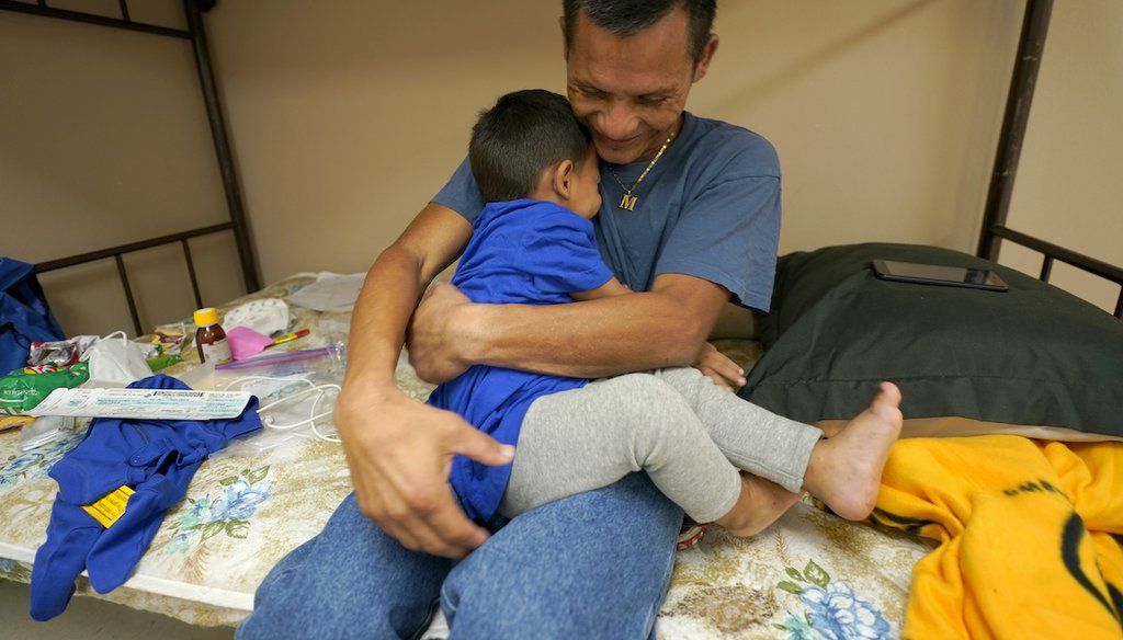 Elmer Maldonado, top, a migrant from Honduras, hugs his 1-year-old son at a shelter, March 22, 2021, in Harlingen, Texas. They spent a week in immigration custody after crossing the Rio Grande through Texas to request asylum. (AP)