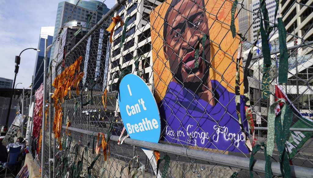 A picture of George Floyd hangs on a fence outside the Hennepin County Government Center on March 30, 2021, in Minneapolis during the trial for former Minneapolis police officer Derek Chauvin. (AP/Mone)