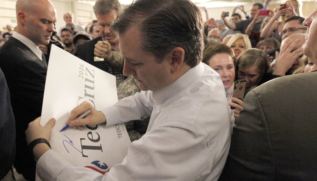 Republican presidential candidate Sen. Ted Cruz, R-Texas, signs an election poster after a rally in Irvine, Calif. on Monday, April 11, 2016. (AP Photo/Nick Ut)