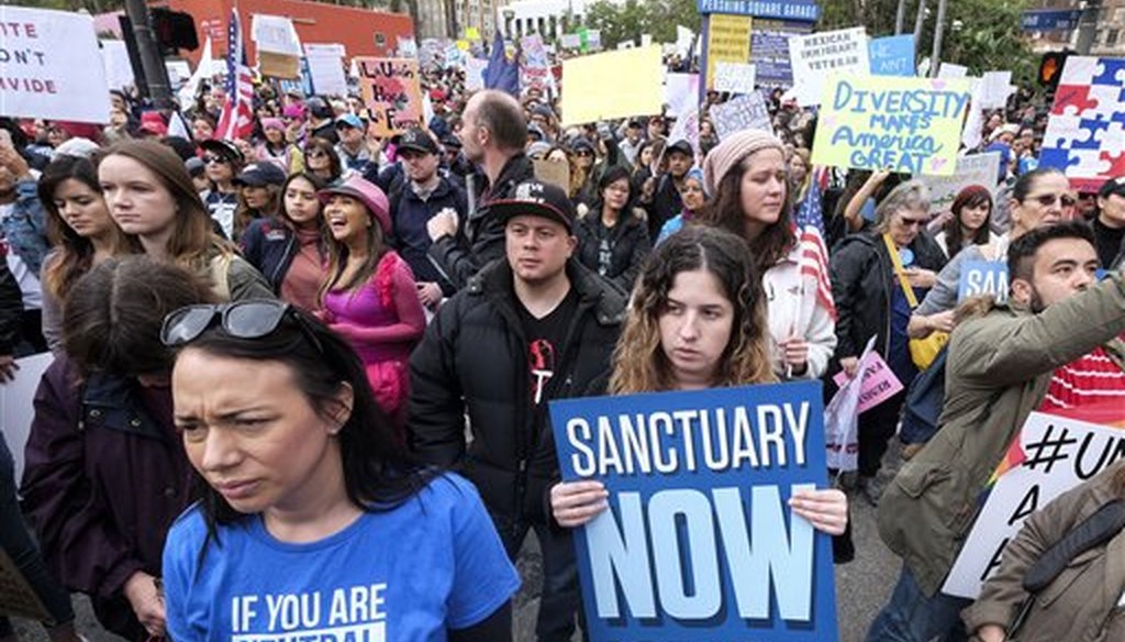 Thousands of people take part in the "Free the People Immigration March,'' to protest actions taken by President Donald Trump and his administration, in Los Angeles on Feb. 18, 2017. (AP/Ringo H.W. Chiu)