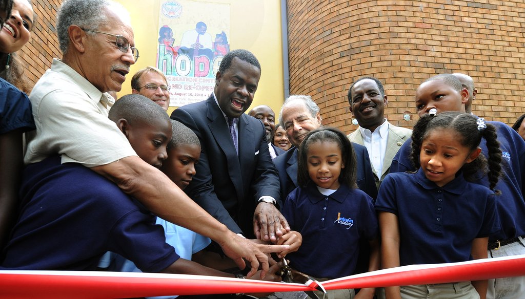 Atlanta Mayor Kasim Reed, center, and Skye Moten, 9, Naiya Portillo, 10, cut the ribbon to officially re-open the Central Park Recreation Center in August 2010. Photo by Johnny Crawford of The Atlanta Journal-Constitution. 