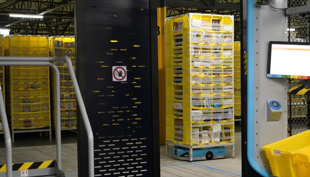 A stack of product-loaded tubs is moved into a stow and picking kiosk at the Amazon Robotic Sorting Fulfillment Center in Madison County, Mississippi, Aug. 11, 2022 (AP)