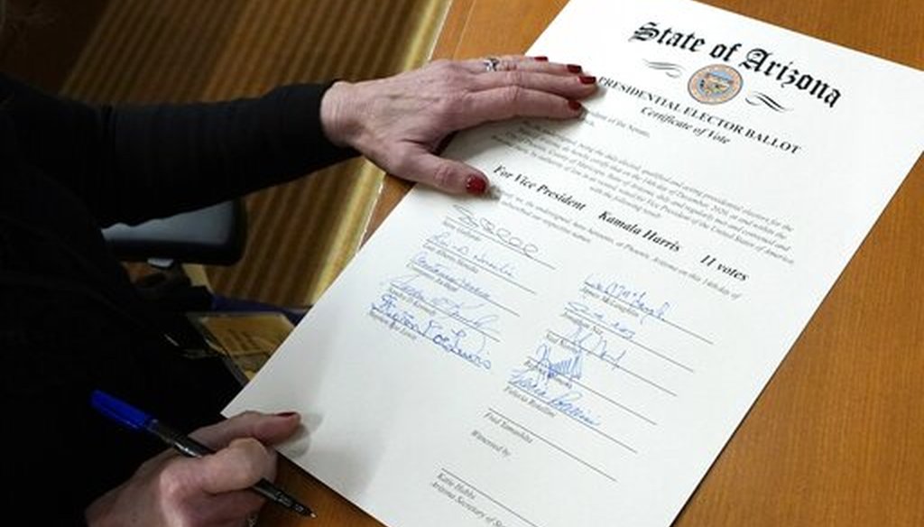 Felecia Rotellini, a member of Arizona's Electoral College, signs the Arizona Presidential Elector Ballot certificate Dec. 14, 2020, in Phoenix. (AP)