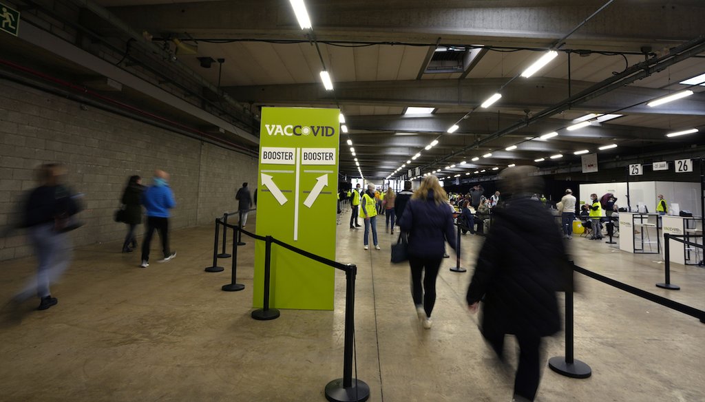 People arrive to receive their Moderna booster vaccine at the Antwerp Expo vaccine center in Antwerp, Belgium on Dec. 27, 2021. (AP)