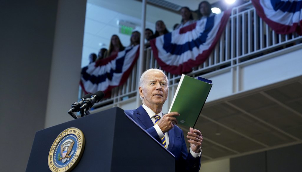President Joe Biden holds a copy of the Republican Study Committee's FY2024 budget proposal as he speaks about his administration's economic agenda during an event at Prince George's Community College in Largo, Md., Sept. 14, 2023. (AP)