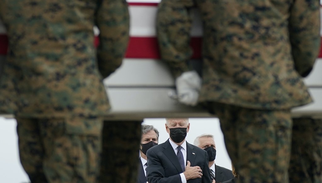 President Joe Biden holds his hand to his heart as a carry team transfers the remains of Marine Corps Lance Cpl. Kareem M. Nikoui, 20, at Dover Air Force Base. Nikoui was one of 13 U.S. service members who were killed in Afghanistan. (AP Photo)