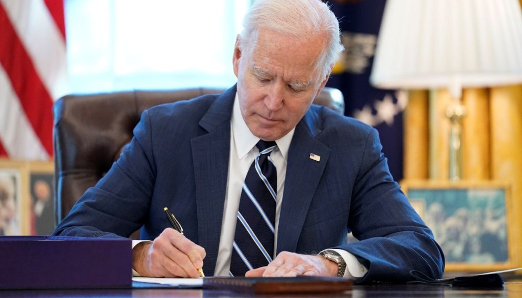President Joe Biden signs the American Rescue Plan, a coronavirus relief package, in the Oval Office on March 11, 2021. (AP)