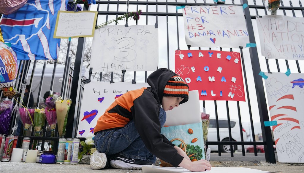 Kollyn Weiler, 10, of Cincinnati, makes a sign for Buffalo Bills safety Damar Hamlin outside UC Medical Center, where Hamlin remains in the hospital, Thursday, Jan. 5, 2023, in Cincinnati. (AP)