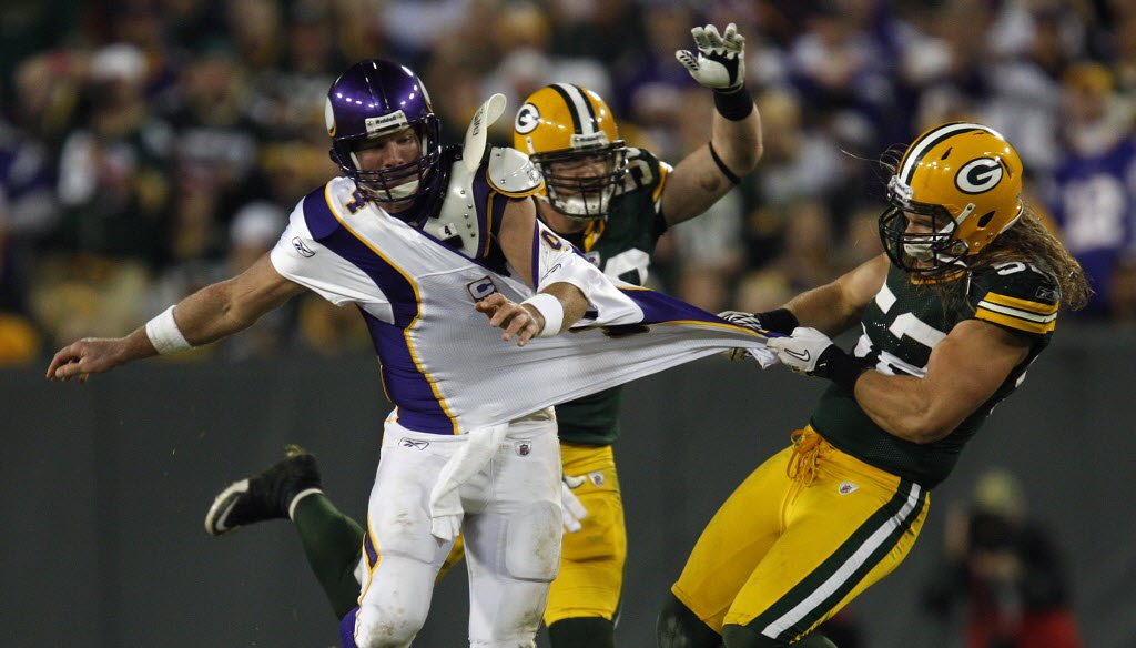 Former Green Bay Packers quarterback Brett Favre, playing for the Minnesota Vikings, is grabbed by Packers defender Clay Matthews during a game at Lambeau Field on Oct. 24, 2010. (Milwaukee Journal Sentinel photo)
