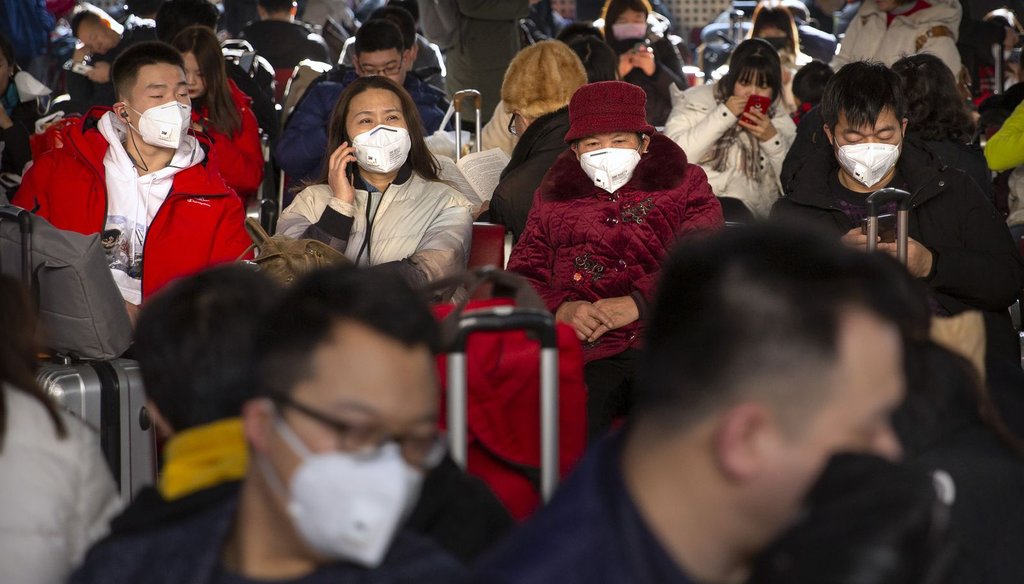 Travelers wear face masks as they sit in a waiting room at the Beijing West Railway Station in Beijing on Jan. 21, 2020. Chinese authorities are responding to an outbreak of a new coronavirus that started in Wuhan, China. (AP)