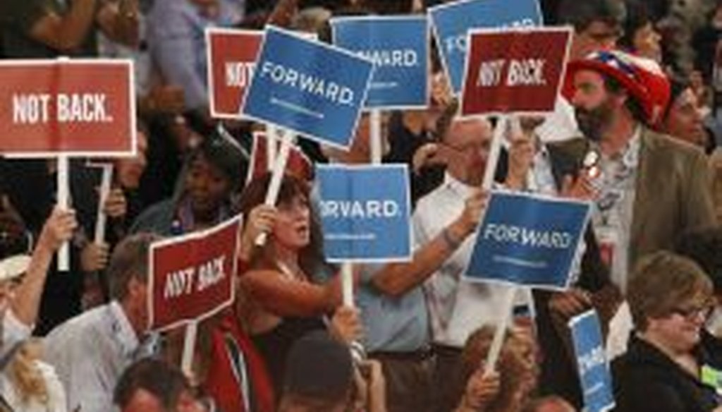 Attendees hold up signs during the Democratic National Convention at the Time Warner Cable Arena in Charlotte, N.C., Sept. 4, 2012.