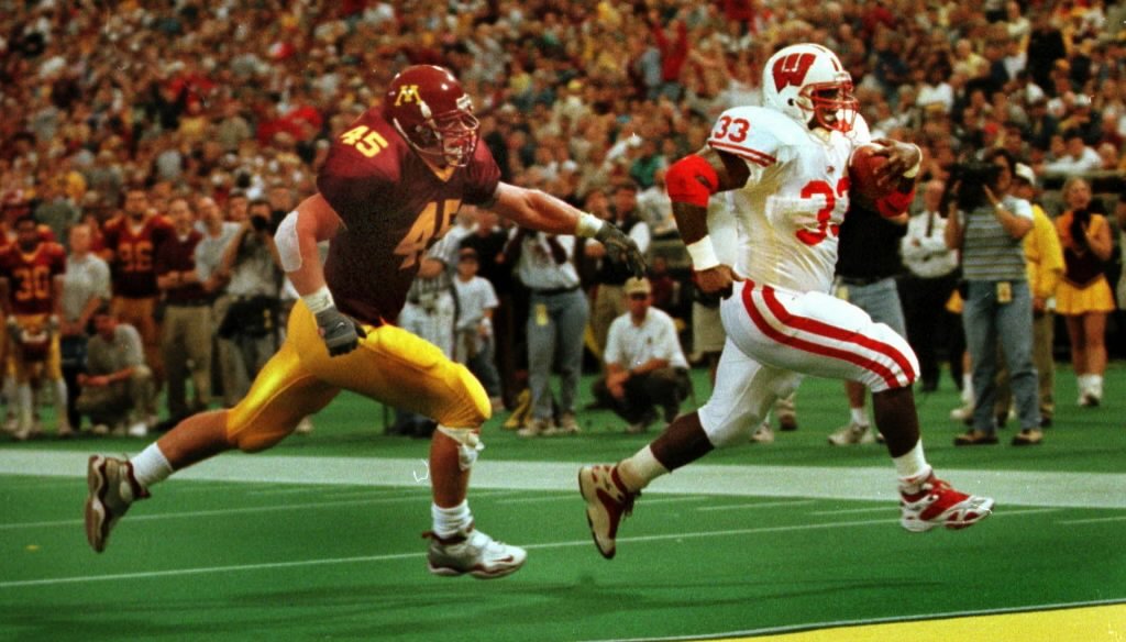 Wisconsin has dominated Minnesota in college football since Badgers running back Ron Dayne was scoring on them, like he did here in 1999. But these days, which state is better for business?