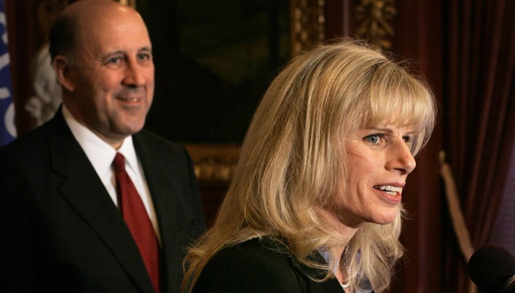 Mary Burke speaks to the media on Jan. 25, 2005, after then-Gov. Jim Doyle (background) announced he had named her his commerce secretary.