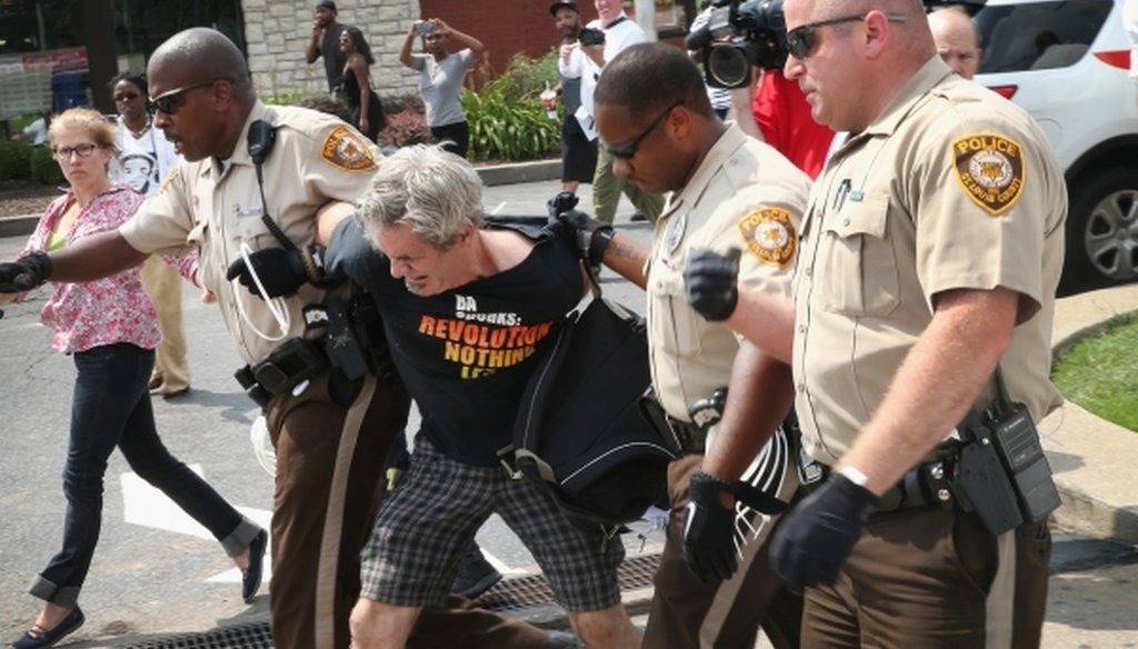 Police arrest a demonstrator protesting the killing of teenager Michael Brown on Aug. 18, 2014, in Ferguson, Mo. (Scott Olson/Getty Images)