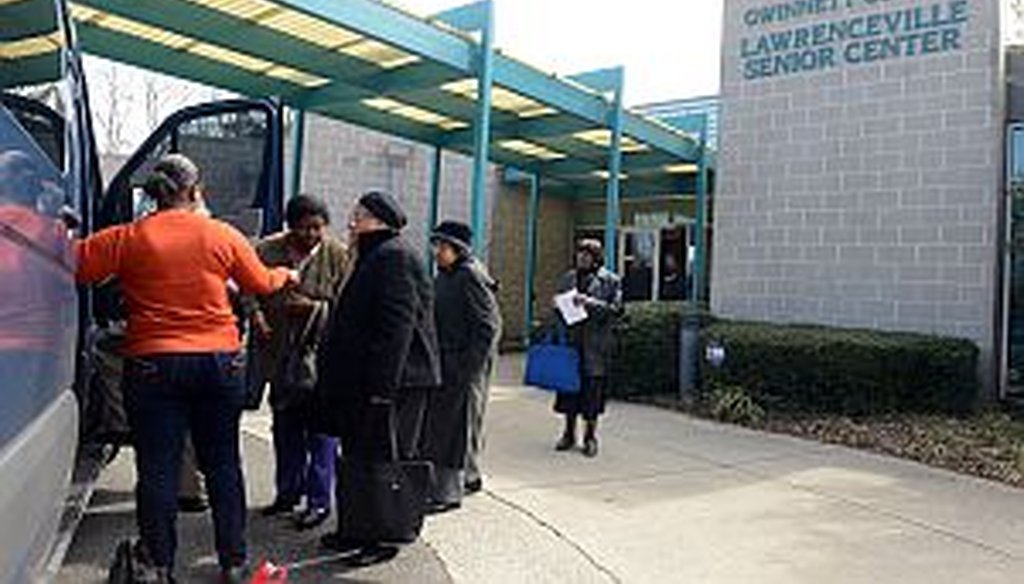 Driver Freddie Johnson helps seniors into a van for a ride home at the Lawrenceville Senior Center last week. Gwinnett Senior Services is expecting funding cuts of $40,000 to $65,000, and plans to reduce the number of meals served and rides offered to sen