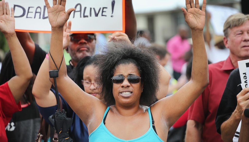 Demonstrators protest near a ramp which leads onto Interstate Highway 70 on Sept. 10, 2014 near Ferguson, Mo.