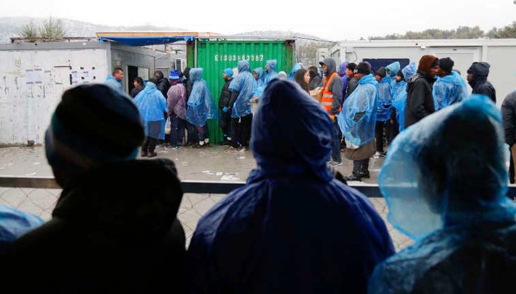 Refugees and migrants line up for food at a camp on the Greek island Lesbos. (AP)