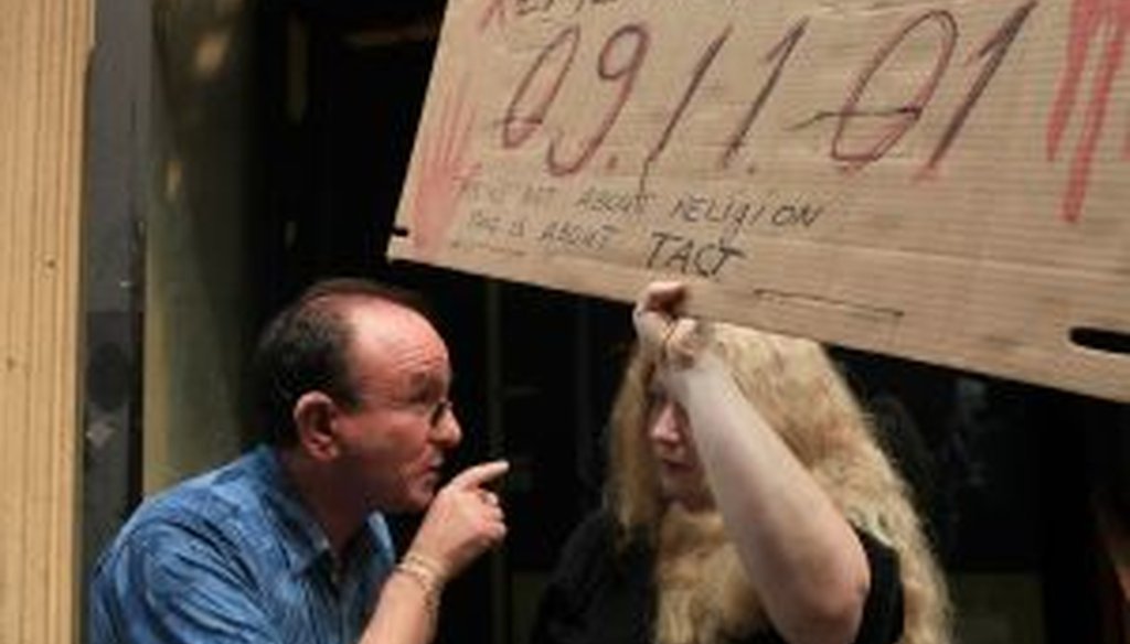 Two people debate outside the proposed site of the mosque and cultural center, which is blocks from Ground Zero in New York City.