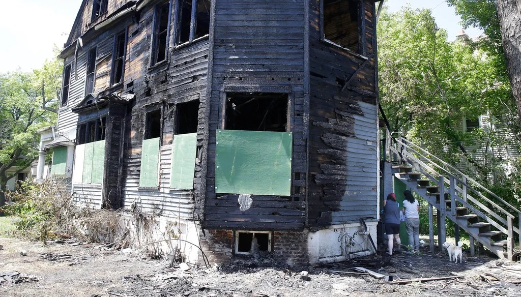 Neighbors collect remnants from outside a home that was burned June 23, 2020, during civil unrest. The duplex was again set on fire the following day, June 24, 2020. (Rick Wood/Milwaukee Journal Sentinel
