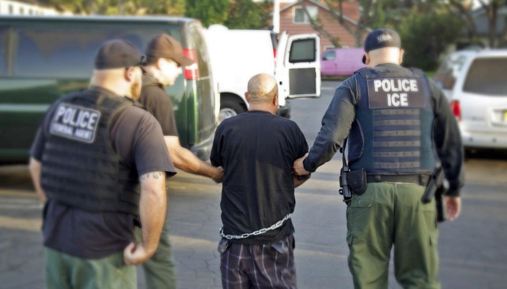 U.S. Bureau of Immigration and Customs Enforcement agents lead a man into custody during an immigration sweep in Ontario, Calif., in October 2014. (AP/U.S. Bureau of Immigration and Customs Enforcement)