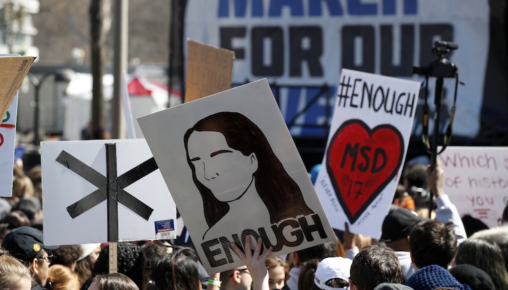 Attendants of the 'March For Our Lives' demonstration hold signs on March 24, 2018 in Washington D.C. (Associated Press)