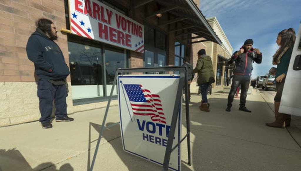 People disembark from a van to participate in early voting Oct. 31, 2018, at Midtown Center, 5700 W. Capitol Drive in Milwaukee, Wis. Nearly 380,000 Wisconsinites have voted early this fall. (Mark Hoffman / Milwaukee Journal Sentinel.)