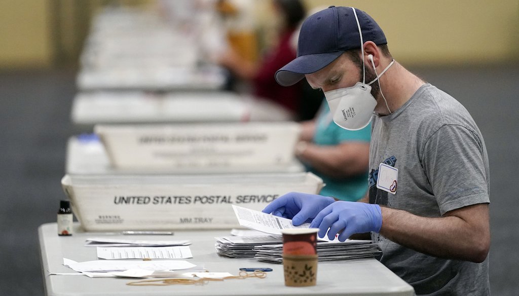Workers prepare mail-in ballots for counting in Lancaster, Pa. (AP Photo/Julio Cortez)