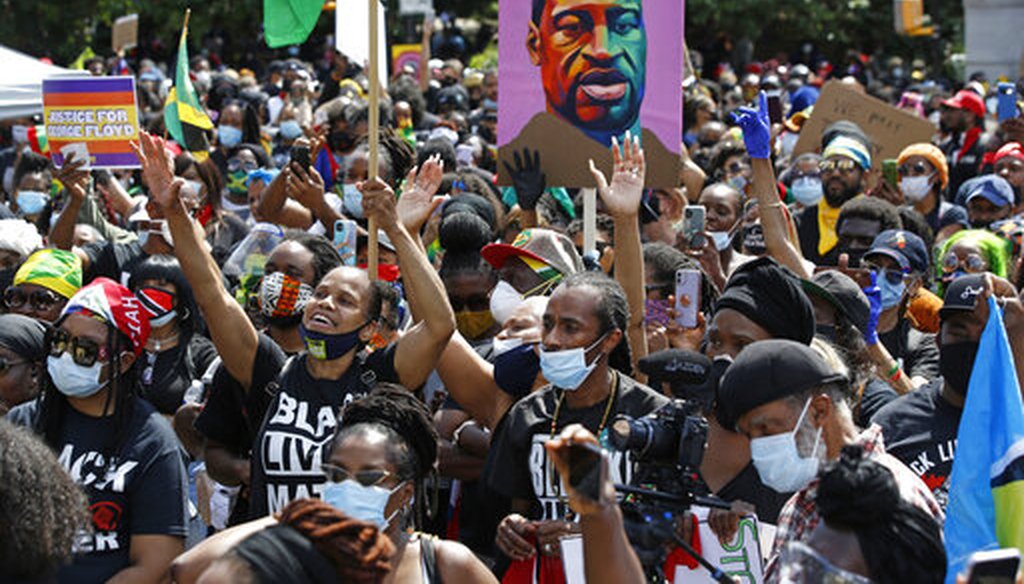 People inspired by a speaker raise their hands during a Caribbean-led Black Lives Matter rally at Brooklyn's Grand Army Plaza, Sunday, June 14, 2020, in New York. (AP)