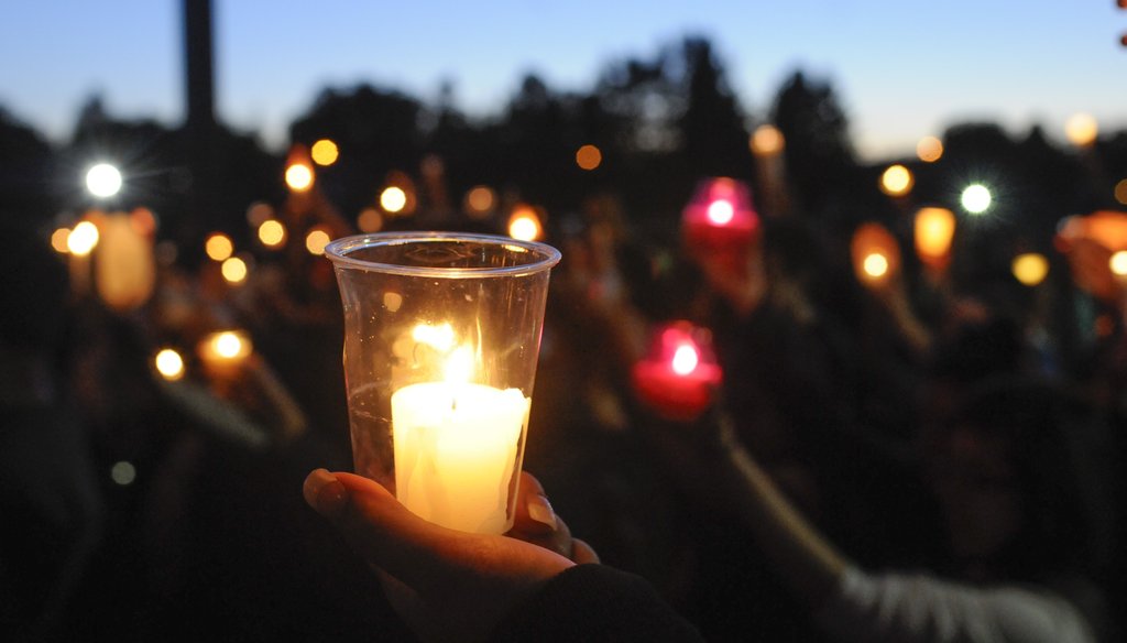 Students, faculty and parents gather for a candlelight vigil to remember a Reynolds High School student shot and killed at the school Tuesday morning. The shooter, also a Reynolds student, took his own life.