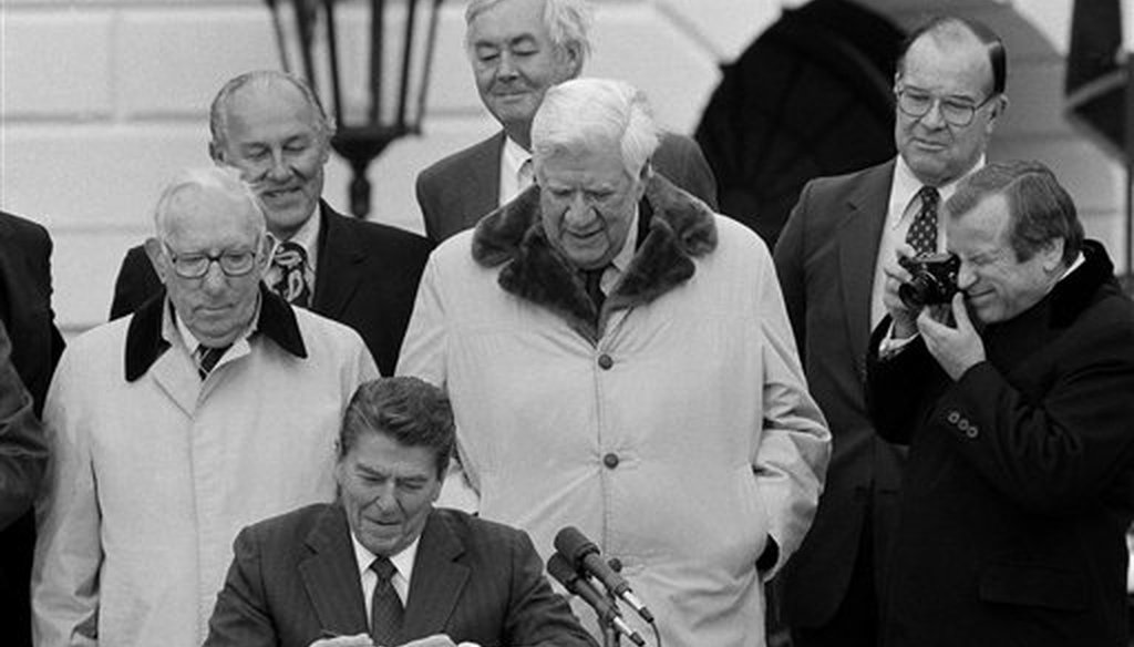 President Ronald Reagan signs the $167 billion dollar Social Security rescue plan during a ceremony on the South Lawn of the White in Washington, April 20, 1983. (AP)