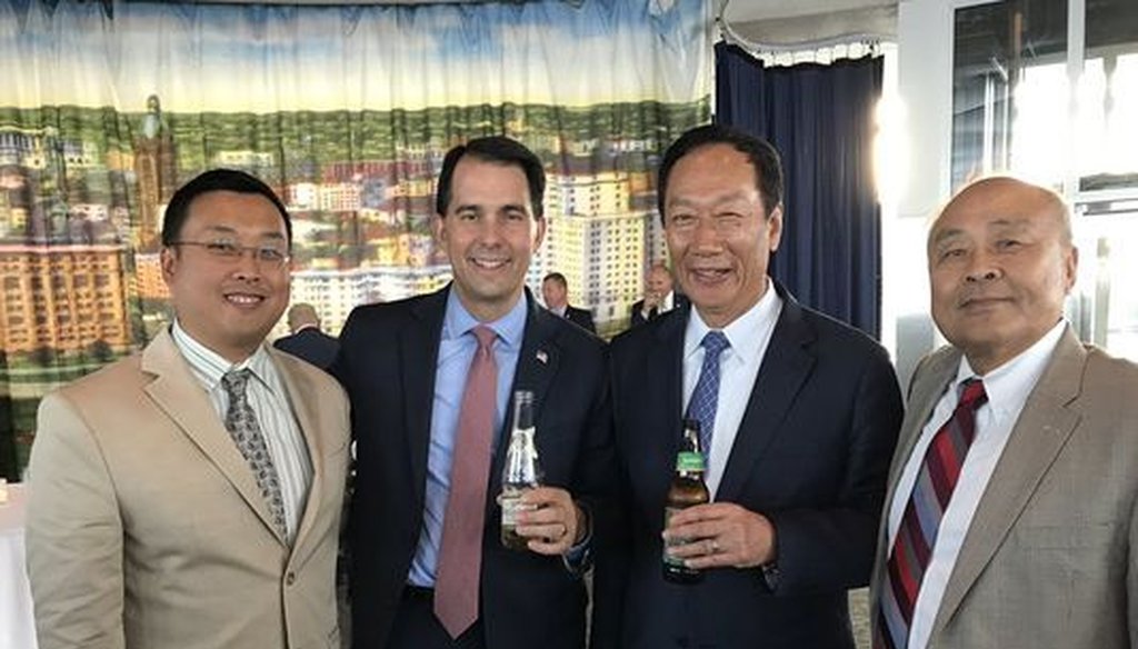 Will Hsu (from left), Gov. Scott Walker, Foxconn chairman Terry Gou and Hsu's father, Paul Hsu, posed for a photo when Walker and Gou signed an agreement in which Foxconn says it will build a manufacturing plant in Wisconsin. (Courtesy Will Hsu)