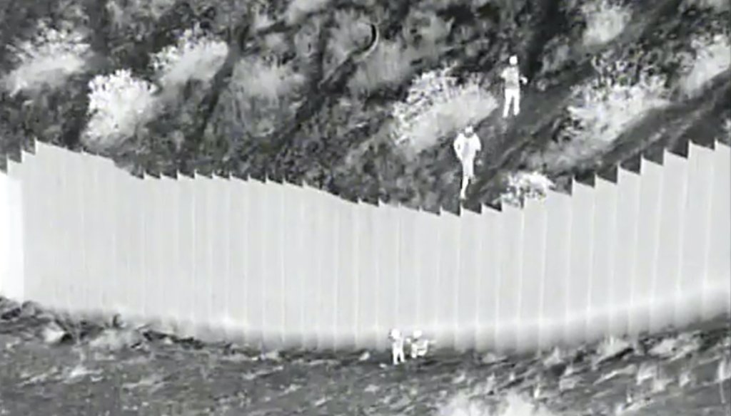 A photo taken from night video provided by the U.S. Customs and Border Protection shows smugglers after they dropped two children from the top of border barrier in Santa Teresa, N.M., on March 30, 2021. (AP)