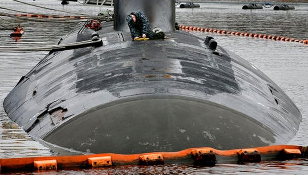 A member of the U.S. Navy performs maintenance on the USS New Mexico submarine on April 26, 2017, in Groton, Conn. (AP/Steven Senne)