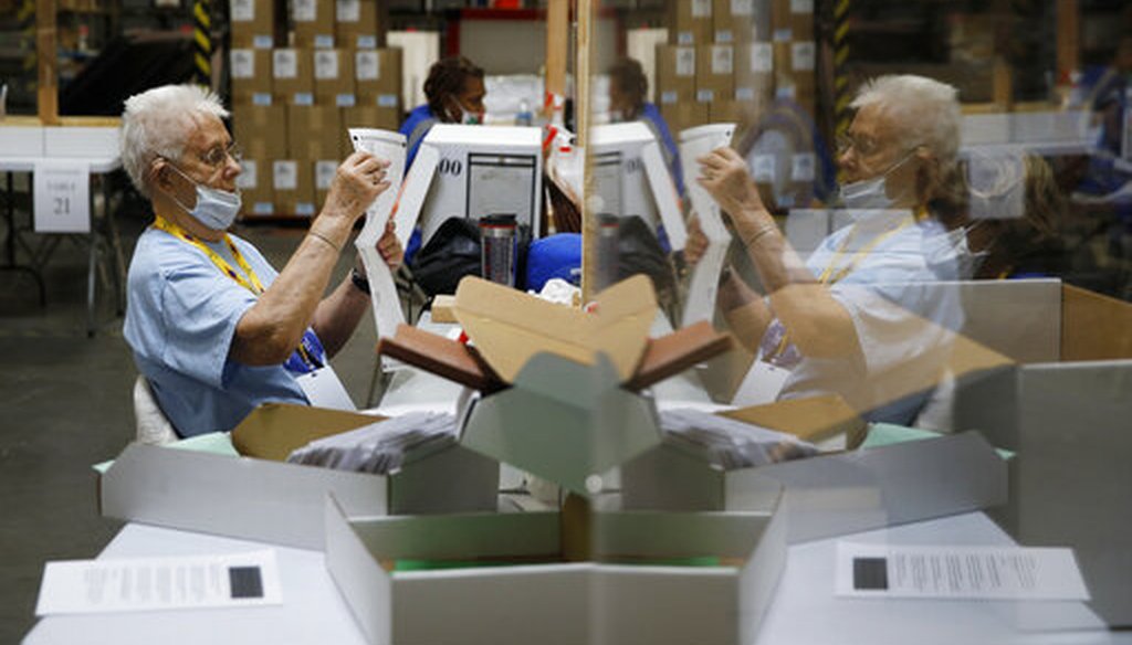 In this June 9, 2020, file photo election workers process mail-in ballots during a nearly all-mail primary election in Las Vegas. (AP)