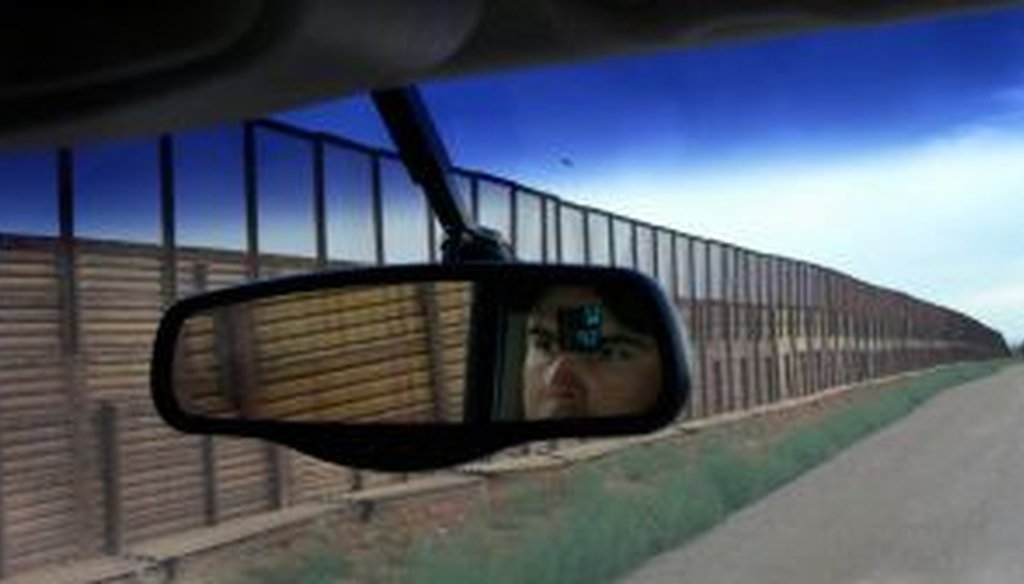 A border patrol agent drives along the border fence in Naco, Arizona. (2010)