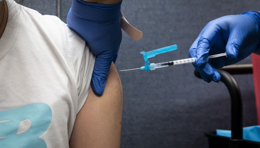 A person receives a COVID-19 vaccine this summer in Chicago's Chinatown neighborhood. | Ashlee Rezin Garcia/Chicago Sun-Times