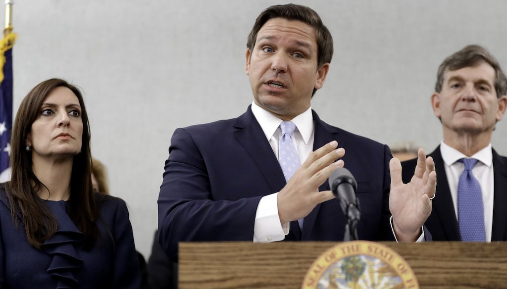 Florida Gov. Ron DeSantis, center, gestures as he stands with Lt. Gov. Jeanette Nunez, left, and State Surgeon General Dr. Scott Rivkees during a news conference March 2, 2020, in Tampa, Fla. (AP)
