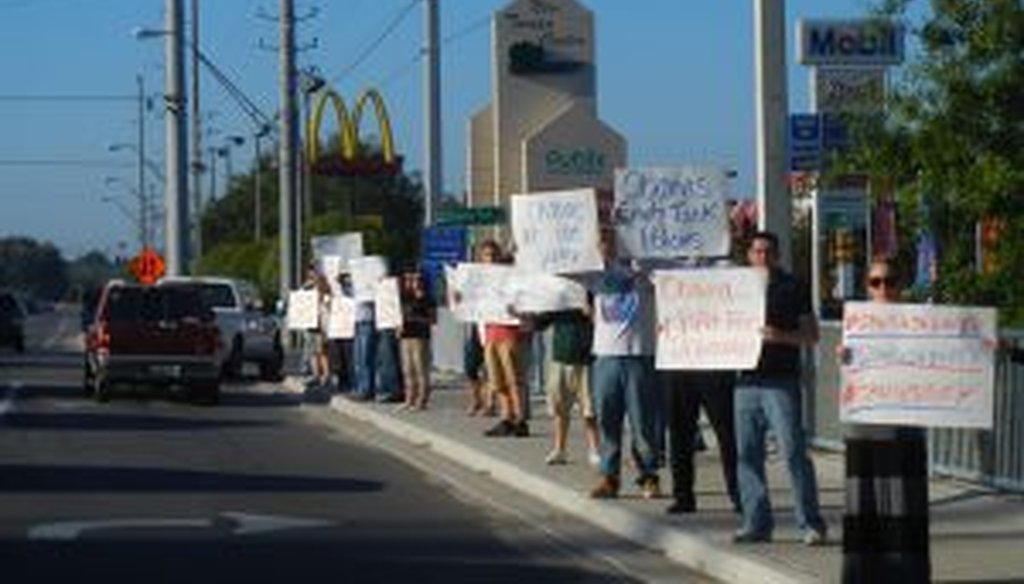 Demonstrators rally along a busy road in Tampa, Fla., to protest the Obama administration's energy policies.